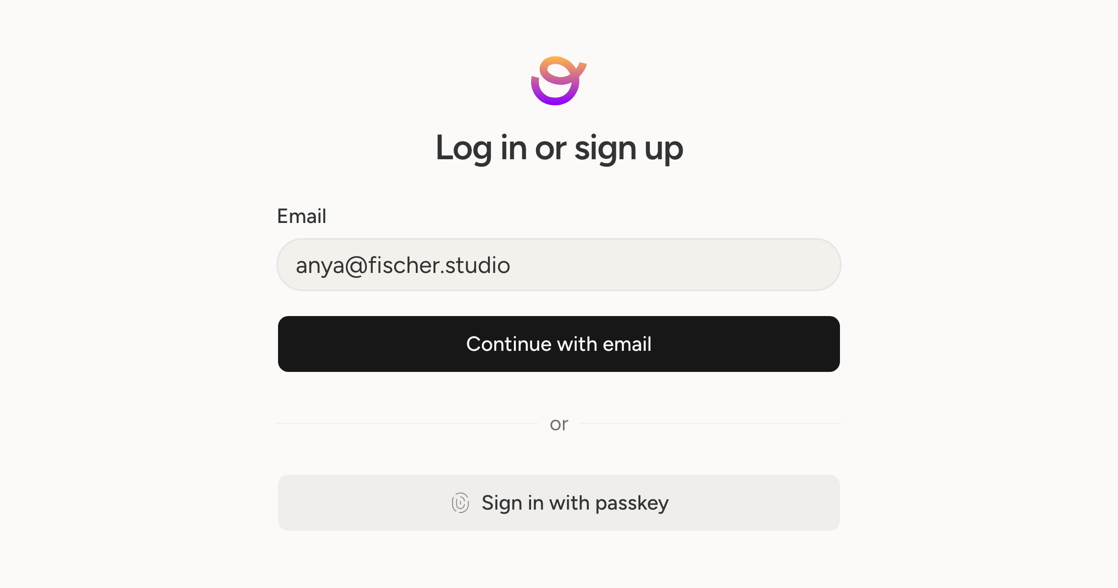 The sign-in screen, with a code to your email and a passkey as the two ways in